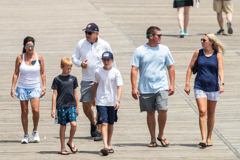 Families stroll the boardwalk in advance of the Rehoboth Beach Independence Day fireworks launch celebration on Sunday, July 2, 2023.