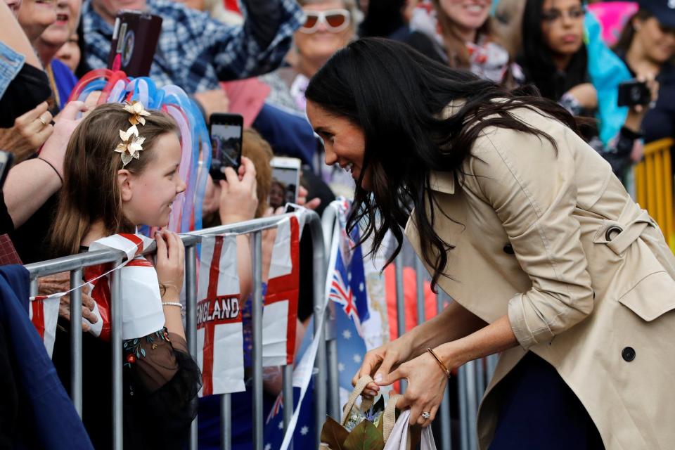 Meghan Markle speaks to a girl in Melbourne (REUTERS)