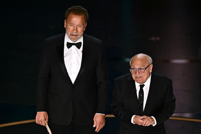 <p>PATRICK T. FALLON/AFP via Getty</p> Arnold Schwarzenegger (left) and Danny DeVito at the 96th Annual Academy Awards on March 10, 2024