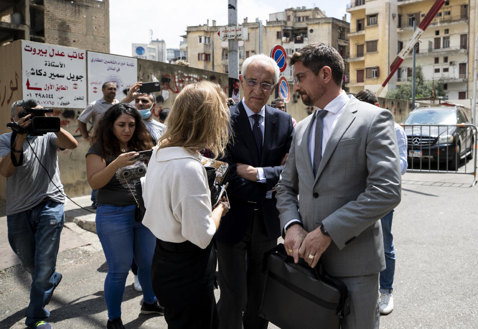 Members of Carlos Ghosn's defense team, lawyer Jean Yves Le Borgne, center, and Jean Tamalet, right, leave the Justice Palace in Beirut, Lebanon, Friday, June 4, 2021. Lawyers of Ex-Nissan boss Carlos Ghosn said on Friday their client has answered hundreds of questions by French and Lebanese investigators over the past week describing him as "happy and satisfied" to be given the opportunity to explain himself over accusations of financial misconduct. (AP Photo/Hassan Ammar)