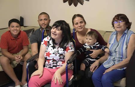 Alma Rivera, 39, sits in her chair with her nephew Gabriel Baez, 14, brother-in-law Isuain Luna, sister Nathalie Rivera, 10-month-old nephew Ixuan Luna and mother Juanita Alvarado (L-R) at their home in Kissimmee, Florida, U.S. December 2, 2016. REUTERS/Phelan Ebenhack