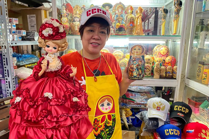 Nguyen Thi Hong Van, a collector and seller of Russian souvenirs who lived and worked in Russia for 20 years, poses at her shop in Hanoi