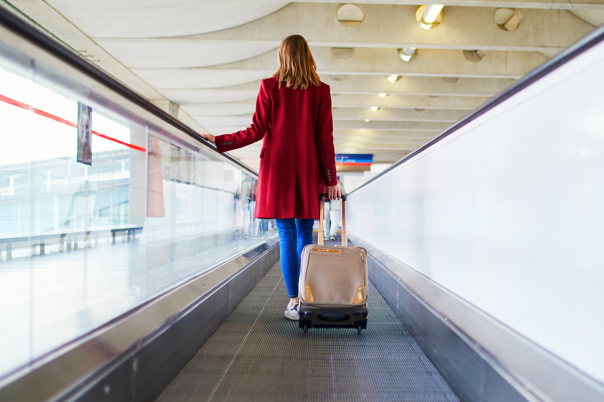 Woman wearing red coat at the airport