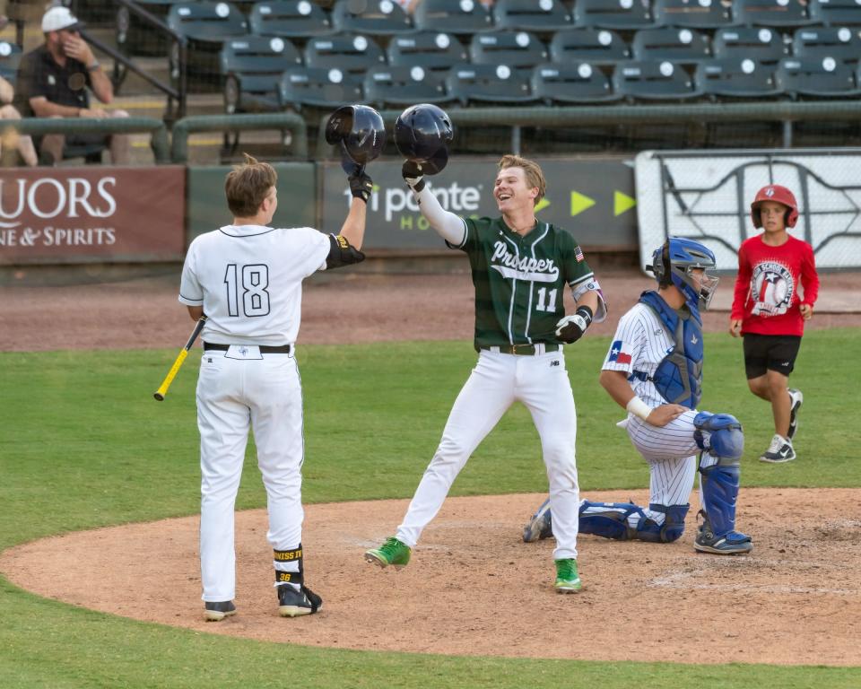 Easton Carmichael (11) from Prosper celebrates with Will Furniss from Nacogdoches after scoring for the North. The South team won 7-3 over the North. The Texas High School Baseball Coaches Association held its All-Star game for 5A and 6A players at Dell Diamond in Round Rock on June 19, 2022.