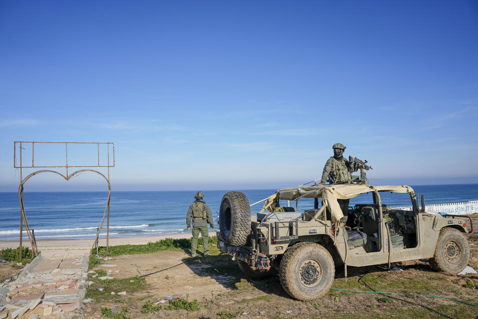 Israeli soldiers take a position on Gaza City beachfront in the Mediterranean Sea during a ground operation inside Gaza, Thursday, Feb. 8, 2024. The Israeli military says it has discovered tunnels underneath the main headquarters of the U.N. agency for Palestinian refugees in Gaza City, alleging that Hamas militants used the space as an electrical supply room. The unveiling of the tunnels marked the latest chapter in Israel's campaign against the embattled agency, which it accuses of collaborating with Hamas. (AP Photo/Ariel Schalit)