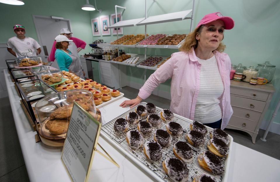 Amy Lovisone takes a pause, with staff behind her, before the door opens at Decked out Donuts, just north of Hanover. 