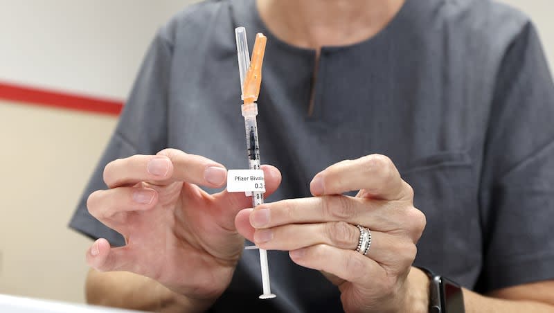 Wendy Dewey, a public health nurse with the Salt Lake County Health Department, prepares a syringe during a free COVID-19 vaccination and testing clinic at the Tongan Methodist Church in West Valley City on Oct. 15, 2022.