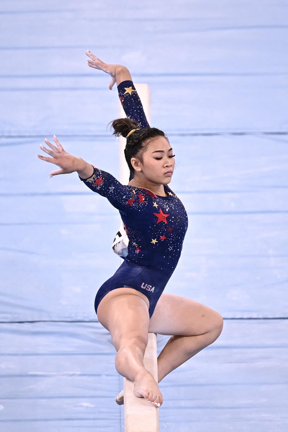 <p>USA's Sunisa Lee competes in the artistic gymnastics balance beam event of the women's qualification during the Tokyo 2020 Olympic Games at the Ariake Gymnastics Centre in Tokyo on July 25, 2021. (Photo by Lionel BONAVENTURE / AFP) (Photo by LIONEL BONAVENTURE/AFP via Getty Images)</p> 