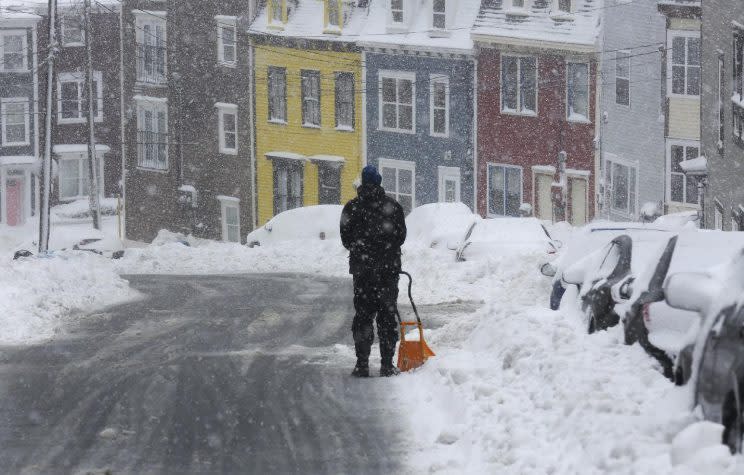 Blair Agnew shovels Wednesday, Feb. 15 in St. John’s, Nfld. Schools and businesses were closed as blizzard conditions continue over the Avalon Peninsula. Photo from the Canadian Press.