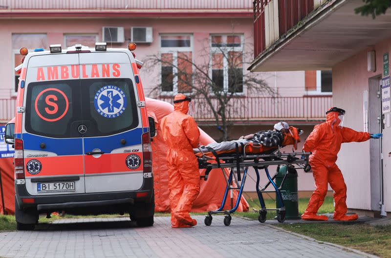 Medical team wearing protective gear brings a patient suspected of coronavirus disease (COVID-19) to a hospital in Bialystok