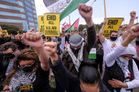 Demonstrators raise their fists during a protest outside the Federal Building against Israel and in support of Palestinians, Saturday, May 15, 2021 in the Westwood section of Los Angeles. (AP Photo/Ringo H.W. Chiu)