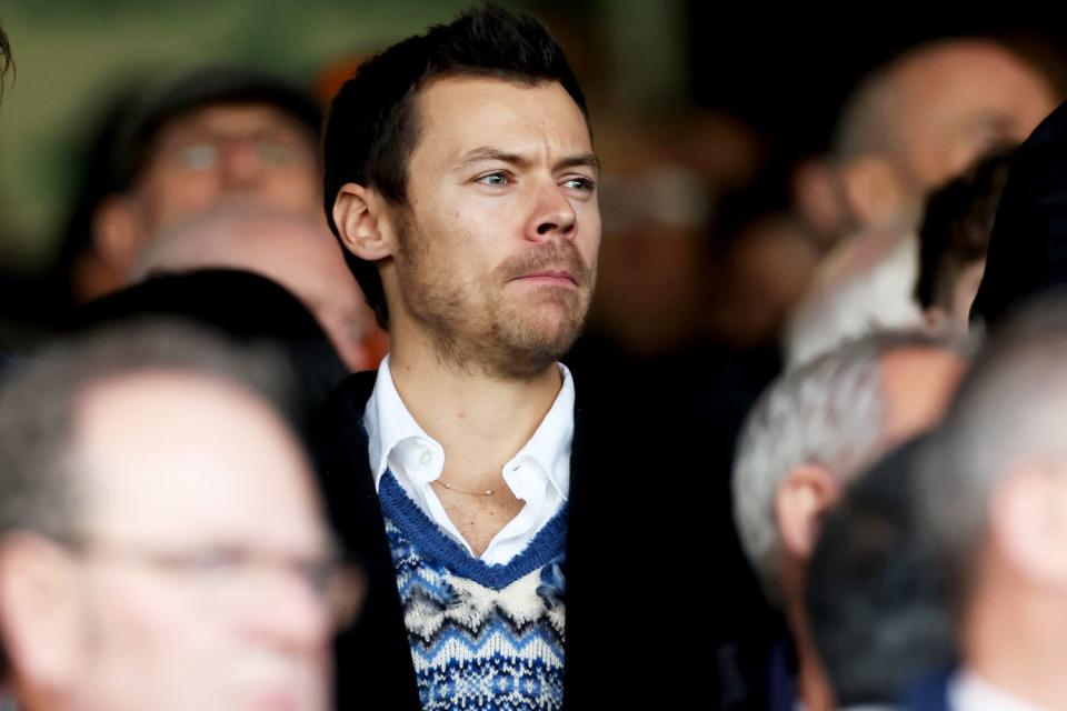 <p>Catherine Ivill/Getty</p> Harry Styles debuts a new haircut at a Premier League match between Luton Town and Manchester United