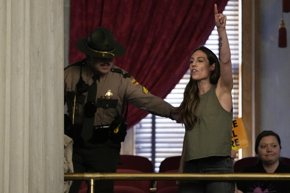 Protester Erica Bowton is removed from the House gallery during a legislative session Thursday, April 25, 2024, in Nashville, Tenn. (AP Photo/George Walker IV)