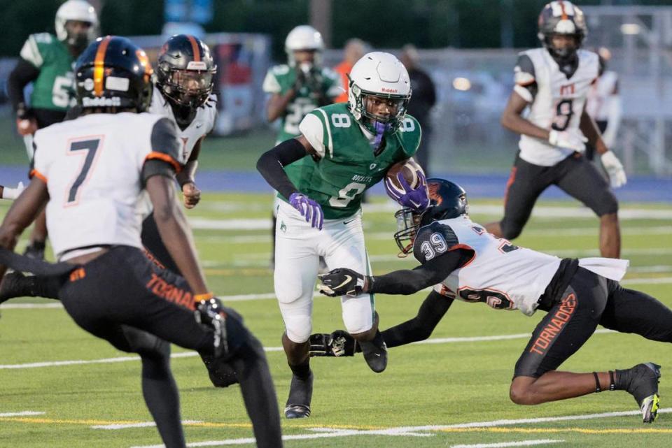 Miami Central Senior High School Rockets wide receiver Lawayne McCoy (8) on a pass reception as Booker T. Washington Senior High School defensive back Antonio Branch (39) attempts to make the stop in the first half at Traz Powell Stadium on Friday, September 9, 2022.