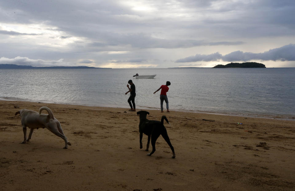 In this Jan. 27, 2019 photo, two boys play by the shore at a beach resort in Talustusan on Biliran Island in the central Philippines. Since December 2018, the small village has been rocked by controversy after about 20 boys and men, including these two, accused their Catholic parish priest Father Pius Hendricks of years of alleged sexual abuse. (AP Photo/Bullit Marquez)