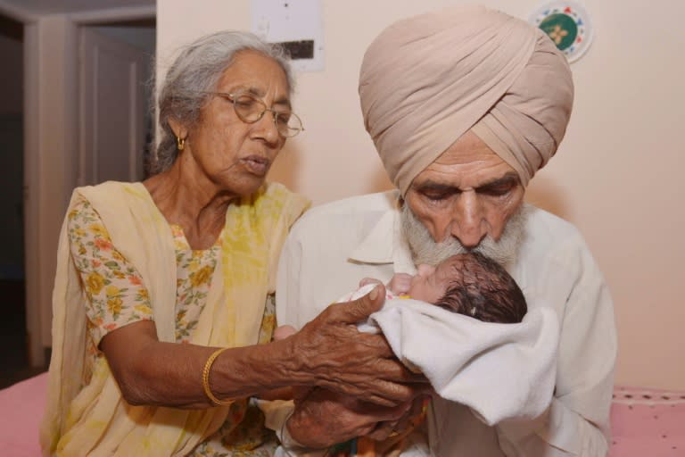 Indian father Mohinder Singh Gill, 79, and his wife Daljinder Kaur, 70, hold their newborn baby boy Arman at their home in Amritsar on May 11, 2016
