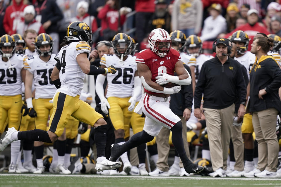 Wisconsin running back Braelon Allen (0) runs against Iowa defensive back Dane Belton (4) during the first half of an NCAA college football game Saturday, Oct. 30, 2021, in Madison, Wis. (AP Photo/Andy Manis)