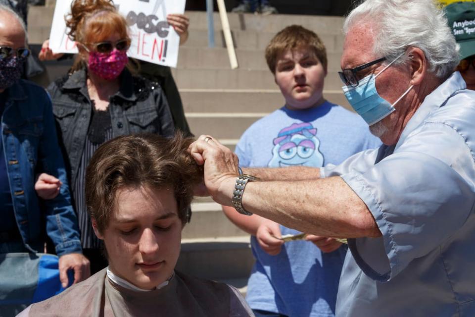 <div class="inline-image__caption"><p>Parker Shonts got a free haircut on the steps of the Michigan State Capitol during a COVID-related protest in 2020.</p></div> <div class="inline-image__credit">Elaine Cromie/Getty Images</div>