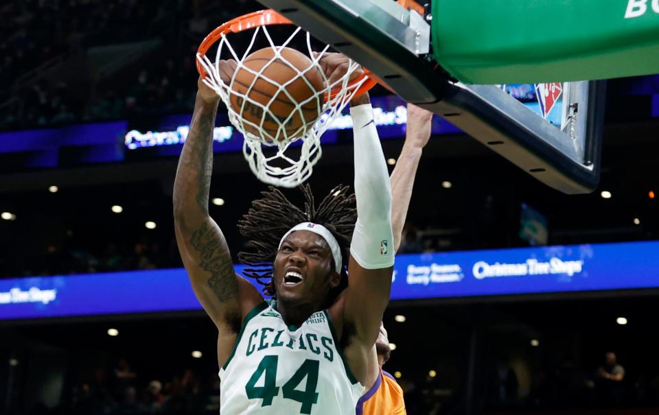 Boston Celtics center Robert Williams III (44) dunks during the second half of an NBA basketball game against the Phoenix Suns, Friday, Dec. 31, 2021, in Boston. (AP Photo/Mary Schwalm)