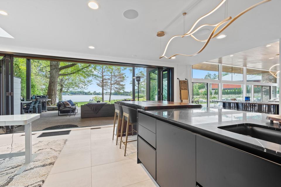 The newly updated kitchen with views of island lake and nano wall leading to the pergola at 3897 Lakeland.