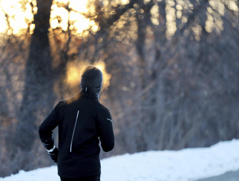 A runner endures the cold while running along West River Parkway, Thursday, Feb. 13, 2020, near downtown Minneapolis, as temperatures hover near minus 30 degrees Fahrenheit with wind chills. (David Joles/Star Tribune via AP)