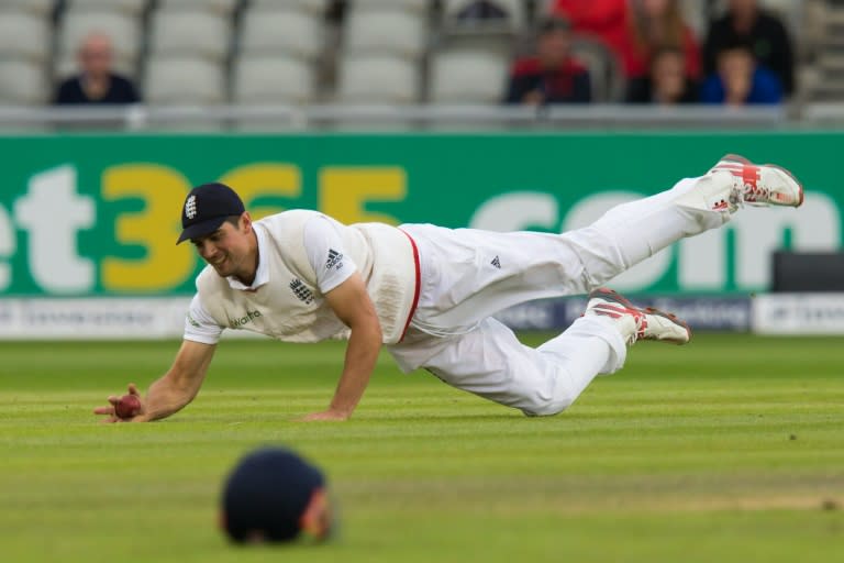 England's Alastair Cook fields off the bowling of Pakistan's Moeen Ali on the 4th day of their 2nd Test match, at Old Trafford Cricket Ground in Manchester, on July 25, 2016