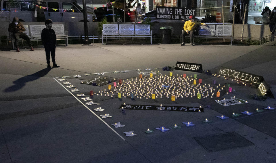 The names of more than sixty persons who died from COVID-19 and associated with Make the Road New York (MRNY), a support organization for immigrant and working class communities, are displayed on butterfly cutouts during a vigil, Thursday May 21, 2020, in Corona Plaza, Queens, N.Y. With support from elected state and city officials, MRNY has launched a campaign called #Recovery4All, demanding Governor Cuomo and Mayor de Blasio create "a $3.5 billion Excluded Workers' Fund, cancel rent, and release at risk people from prisons and detention centers" to address the disproportionate effects from the pandemic in Queens. (AP Photo/Bebeto Matthews)