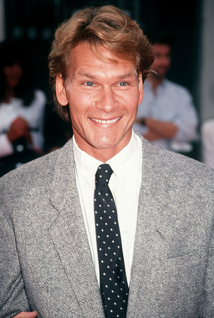 Close-up of Patrick smiling in a suit and tie