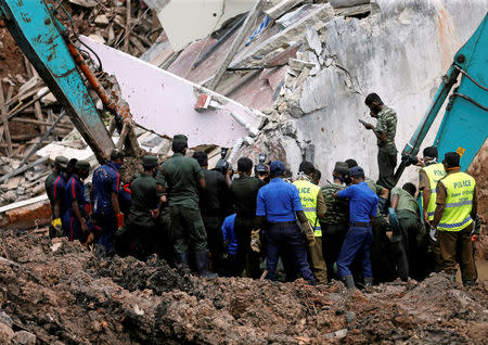 Members of the military work during a rescue mission after a garbage dump collapsed and buried dozens of houses in Colombo, Sri Lanka April 16, 2017. REUTERS/Dinuka Liyanawatte