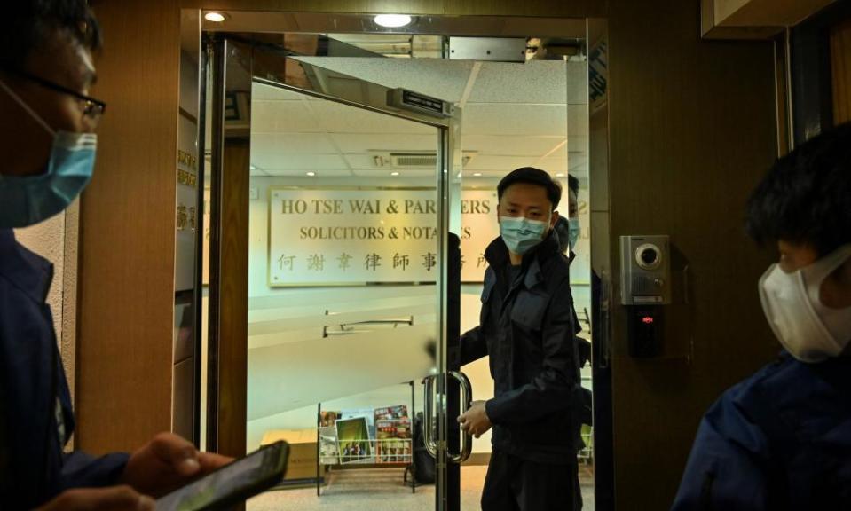 Police are seen inside the office of former pro-democracy lawmaker and lawyer Albert Ho after as many as 50 Hong Kong opposition figures were arrested