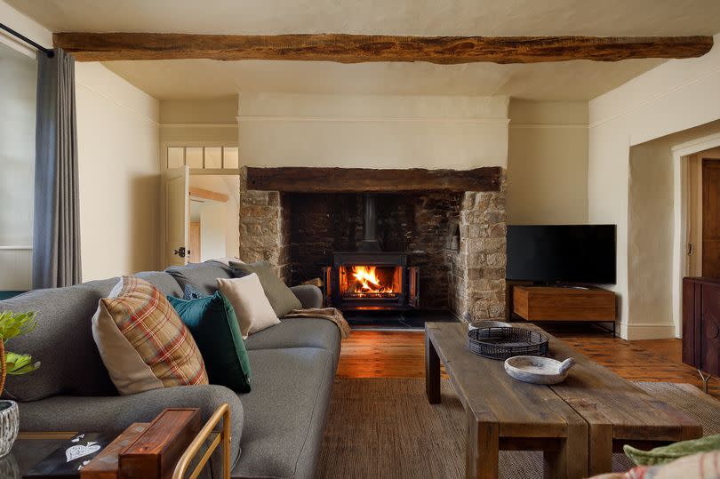Inside the farmhouse is a large sitting room with inglenook fireplace