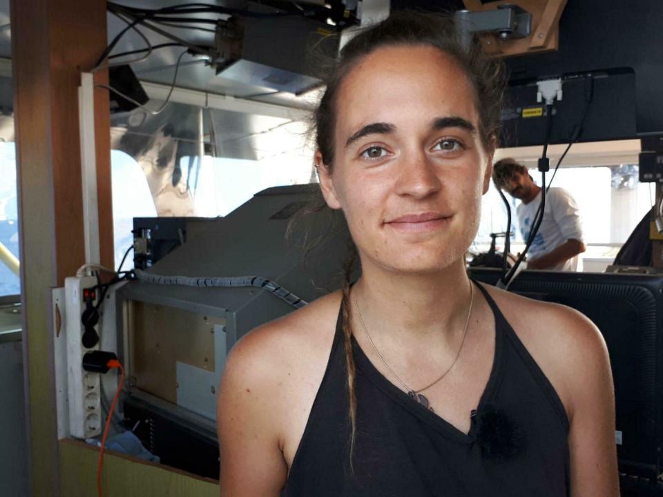 Sea-Watch 3 captain Carola Rackete is seen on board the vessel at sea in the Mediterranean, just off the coasts of the southern Italian island of Lampedusa, Thursday, June 27, 2019. The captain of the humanitarian rescue ship says that Italian law enforcement officials have told them that a resolution is near for 42 migrants rescued at sea that Italy’s populist government has so far refused to allow to disembark. (ANSA/Matteo Guidelli via AP)