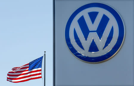 FILE PHOTO: An American flag flies next to a Volkswagen car dealership in San Diego, California, U.S. September 23, 2015. REUTERS/Mike Blake/File Photo