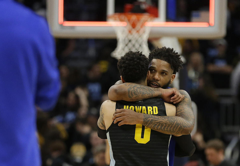 FILE - In this Feb. 29, 2020, file photo, Seton Hall's Myles Powell hugs Marquette's Markus Howard (0) after an NCAA college basketball game in Milwaukee. Powell and Howard went head to head during the regular season in a pair of games befitting two of college basketball's most dynamic players. The potential for a third meeting washed away with the cancellation of the Big East tournament, then NCAA tournament. (AP Photo/Aaron Gash, File)