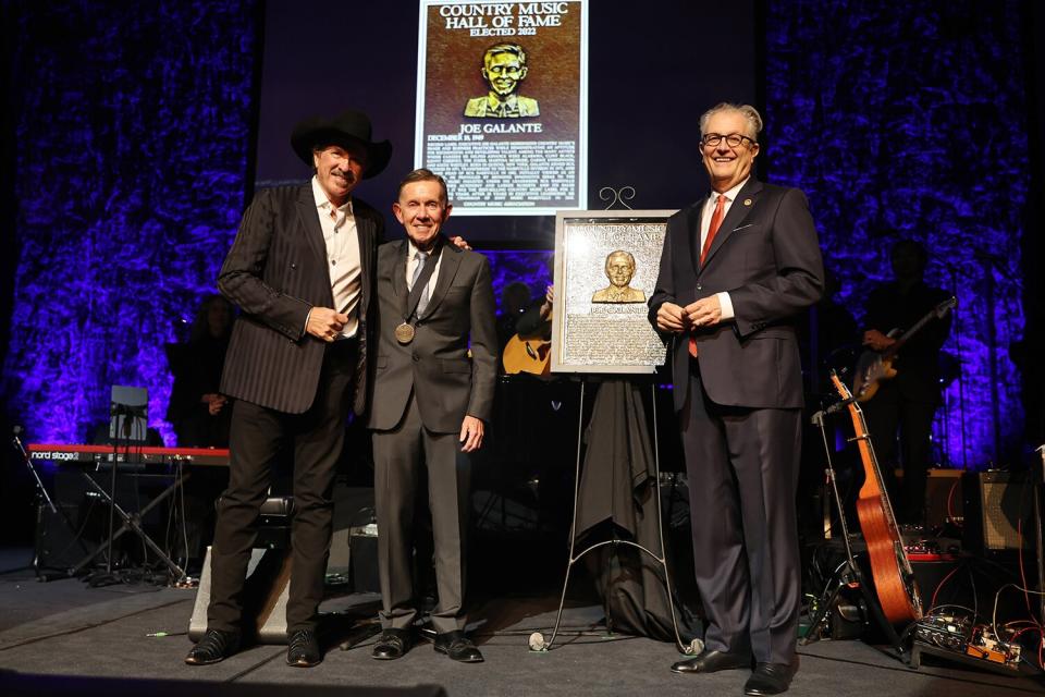 Joe Galante inducted into the Country Music Hall of Fame, presented by Kix Brooks (L) and CEO of the Country Music Hall of Fame and Museum, Kyle Young (R) during the class of 2022 Medallion Ceremony at Country Music Hall of Fame and Museum on October 16, 2022 in Nashville, Tennessee.