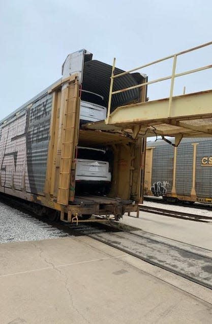 General Motors' full-size SUVs, built at its plant in Arlington, Texas, are loaded onto a rail car’s auto rack in March 2023.