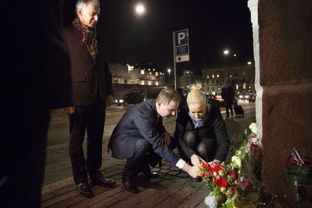 Nicolai Wammen, Danish Minister of Defence, lights a candle in front of the French Embassy in Copenhagen, January 7, 2015, following a shooting by gunmen at the offices of weekly satirical magazine Charlie Hebdo in Paris. REUTERS/Erik Refner/Scanpix Denmark