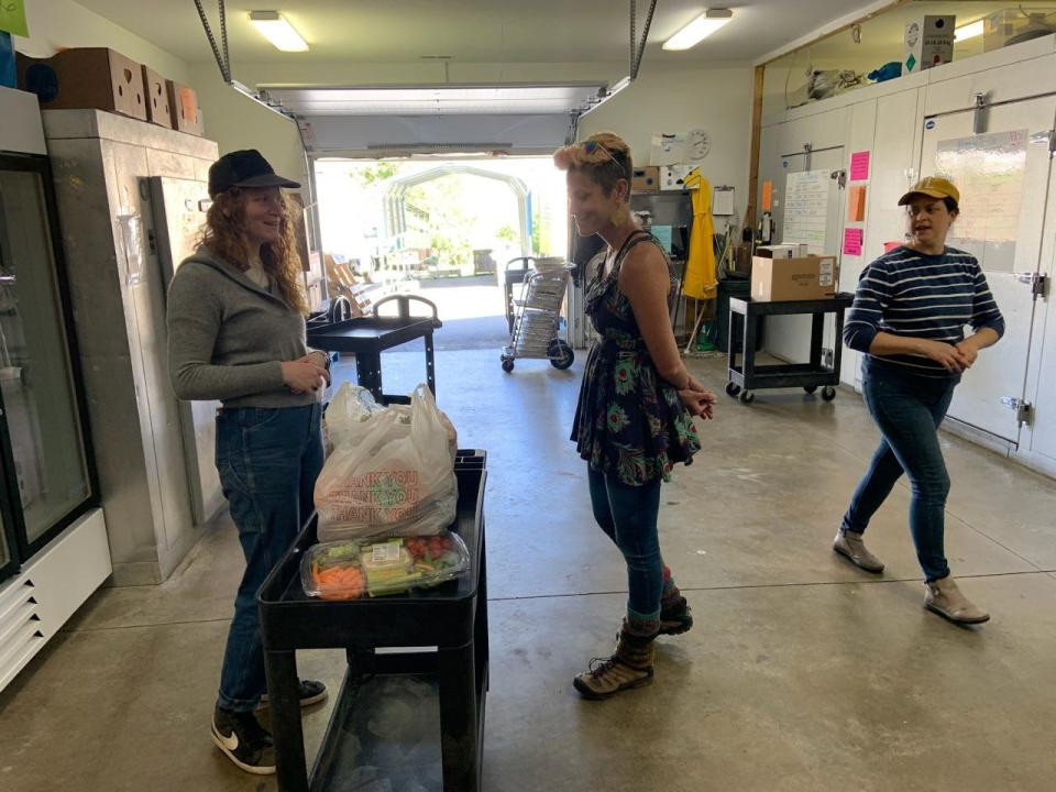 From left, thrift store manager Norwood Schoenke, executive director Jessi Koontz and volunteer Rachael Giesenshlag perform an inventory April 12.