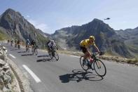 Team Sky rider Chris Froome of Britain (R), race leader's yellow jersey, cycles along the Tourmalet pass during the 188-km (116.8 miles) 11th stage of the 102nd Tour de France cycling race from Pau to Cauterets in the French Pyrenees mountains, France, July 15, 2015. REUTERS/Eric Gaillard TPX IMAGES OF THE DAY