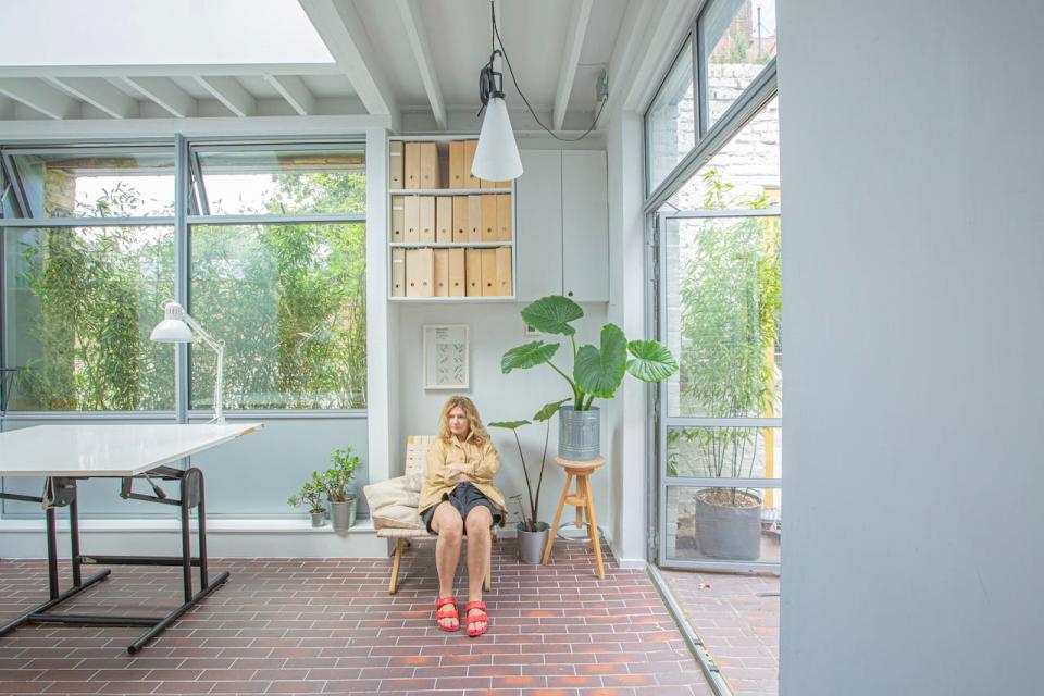 Richard Brown's fiancé Katrina sitting in their triangle-shaped home.