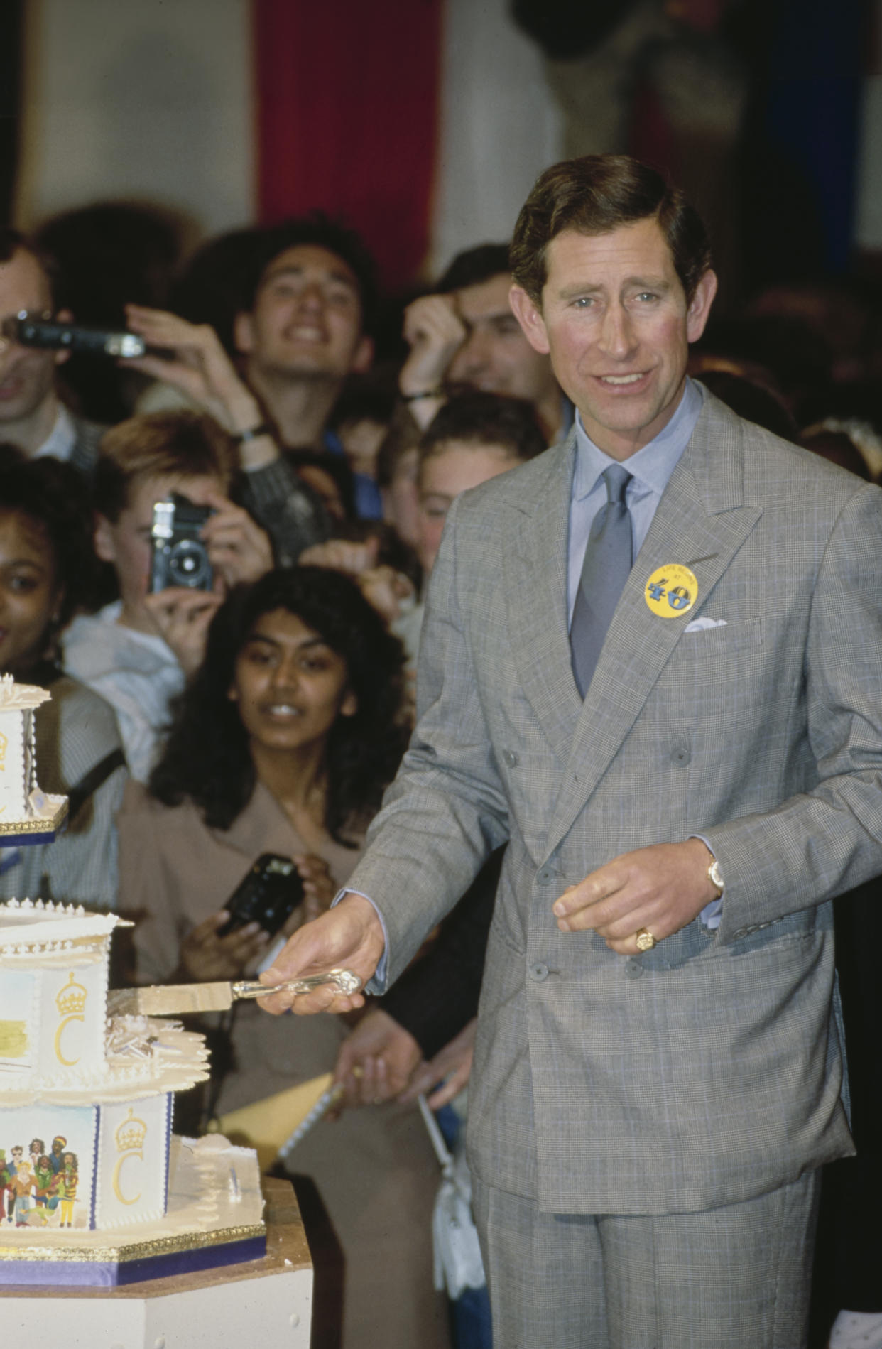 Prince Charles cuts his tiered birthday cake at his 40th Birthday party during the launch of his Princes Youth Business Trust in Birmingham, England, 11th November 1988. (Photo by Tim Graham Photo Library via Getty Images)