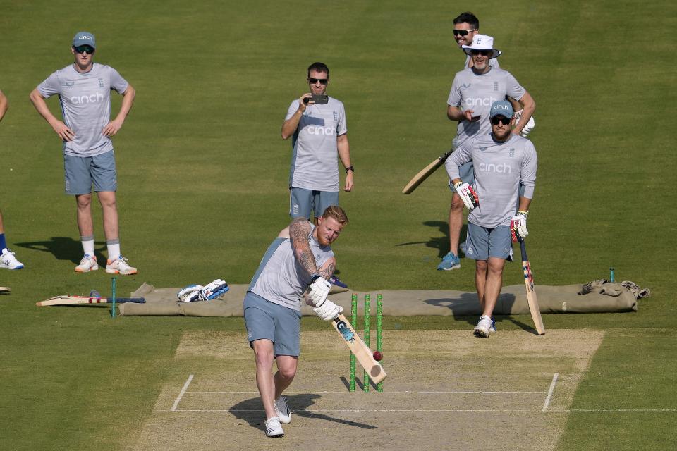 England's skipper Ben Stokes, center bottom, plays a shot as team's coach Brendon McCullum, right, and others watch during a training session, in Karachi, Pakistan, Friday, Dec. 16, 2022. (AP Photo/Fareed Khan)