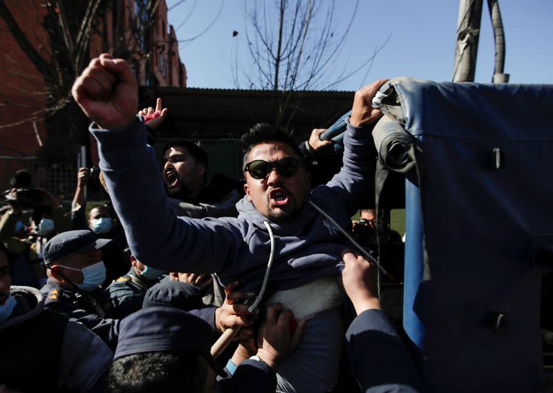 A protester gets detained in front of the supreme court in Kathmandu