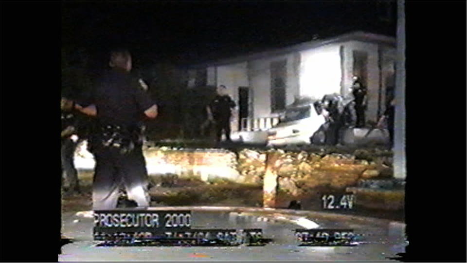 This image from a video released by the U.S. Supreme Court from a dashboard camera video shows police officers at the scene where a car driven by Donald Rickard on July 17, 2004, crashed. Rickard led police officers from West Memphis, Ark., across the Mississippi River into Memphis, Tenn., on a high-speed chase. Rickard and passenger Kelly Allen were shot to death by officers. The Supreme Court is considering an appeal from the officers who say they did nothing wrong and should not be held financially liable for the deaths. Supreme Court justices on March 4, 2014, seemed poised to rule for police officers involved in a high-speed chase that ended with the deaths of the fleeing driver and his passenger. The video was not shown in court, but justices had seen it as part of filings with the court. (AP Photo/U.S. Supreme Court)