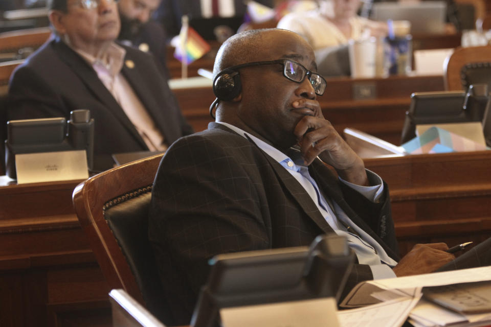 Kansas state Rep. K.C. Ohaebosim, D-Wichita, watches an electronic tally board in the House as members approve proposals aimed at limiting land ownership and the state's economic involvement with companies and individuals from China and other U.S. adversaries, Wednesday, March 27, 2024, at the Statehouse in Topeka, Kan. Ohaebosim opposes the measures. (AP Photo/John Hanna)