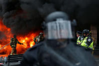 Police and firefighters stand near a limousine which was set ablaze during a protest against U.S. President Donald Trump on the sidelines of the inauguration in Washington, D.C., U.S., on January 20, 2017. REUTERS/Adrees Latif