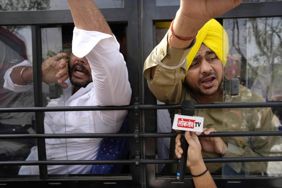 Members of Aam Admi Party, or Common Man's Party, shout slogans as they are detained by police during a protest against the arrest of their party leader Arvind Kejriwal in New Delhi, India, Tuesday, March 26, 2024. Indian police have detained dozens of opposition protesters and prevented them from marching to Prime Minister Narendra Modi’s residence to demand the release of their leader and top elected official of New Delhi who was arrested last week in a liquor bribery case. (AP Photo/Manish Swarup)