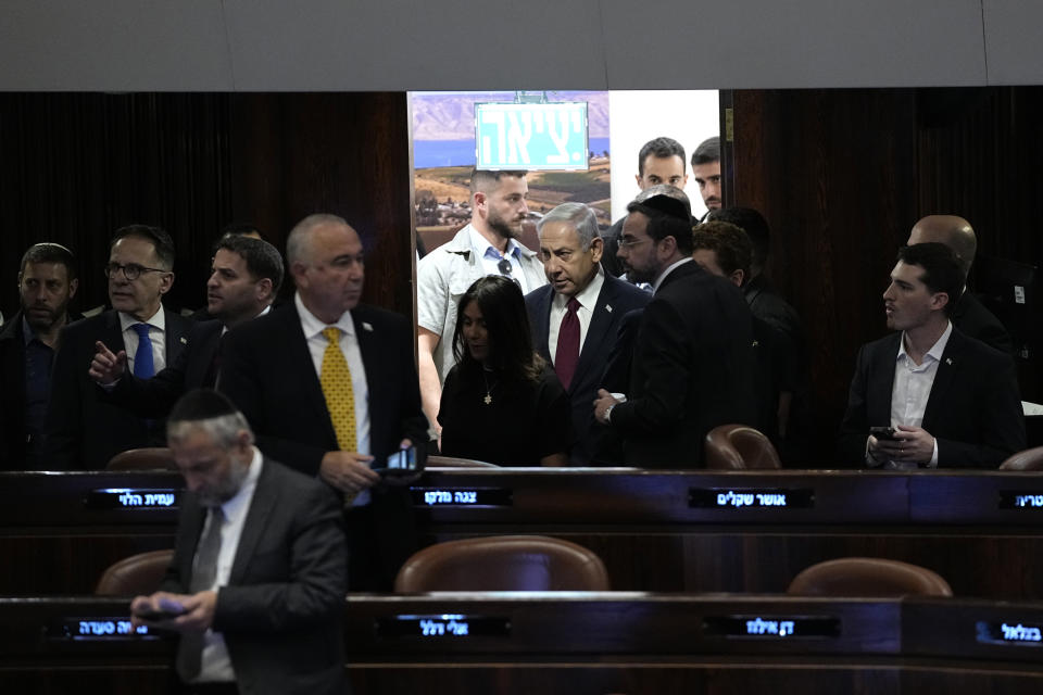 Israeli Prime Minister Benjamin Netanyahu, center right, arrives for a vote on picking two lawmakers to serve on a judge selection panel, in the Knesset, Israel's parliament, Jerusalem, Wednesday, June 14, 2023. (AP Photo/Ohad Zwigenberg)