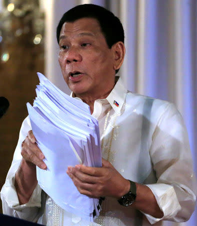 Philippine President Rodrigo Duterte shows to the newly promoted officials of the Philippine National Police (PNP) the 'Narco lists', which name people involved in the illegal drug trade, during a speech at the Malacanang presidential palace in metro Manila, Philippines January 19, 2017. REUTERS/Romeo Ranoco