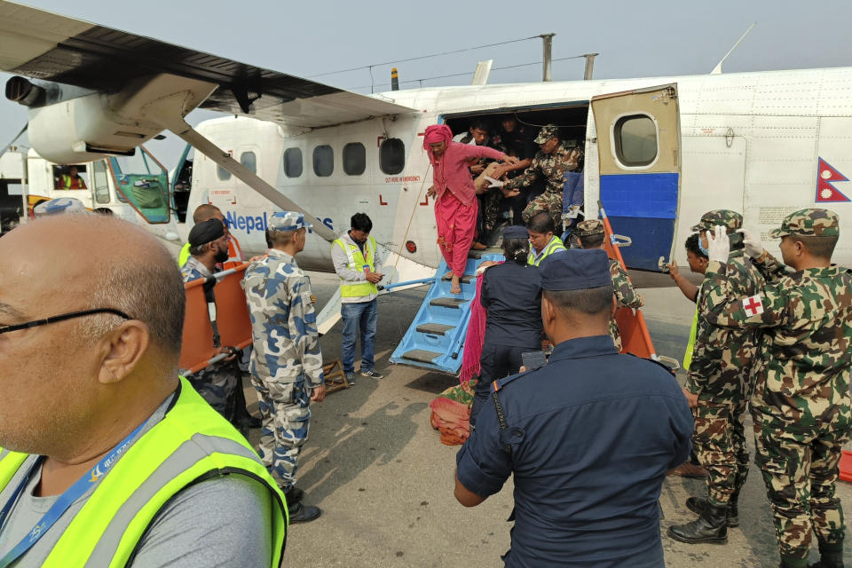 People airlifted from an earthquake-affected area arrive in Nepalgunj, Nepal, Saturday, Nov. 4, 2023. A strong earthquake has shaken northwestern Nepal, and officials say more than 100 people are dead and dozens more injured as rescuers search mountain villages. (AP Photo/Krishna Adhikari)